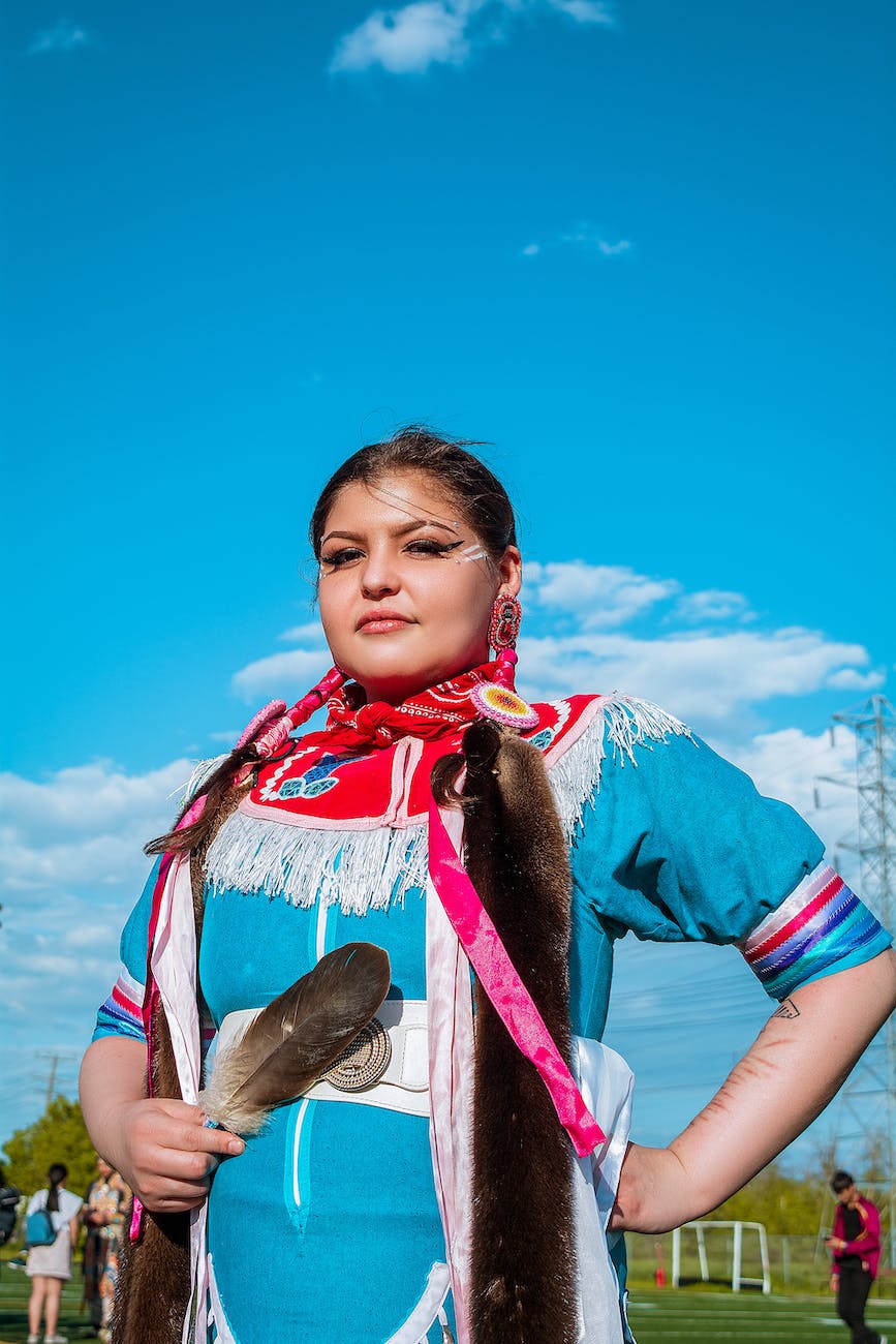 woman in a costume holding a feather