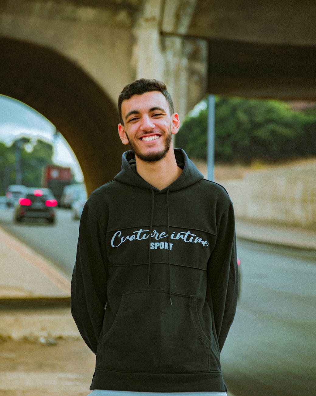 smiling man in black hoodie