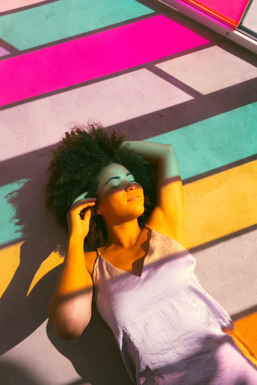 women lying near to a multicolored glass window