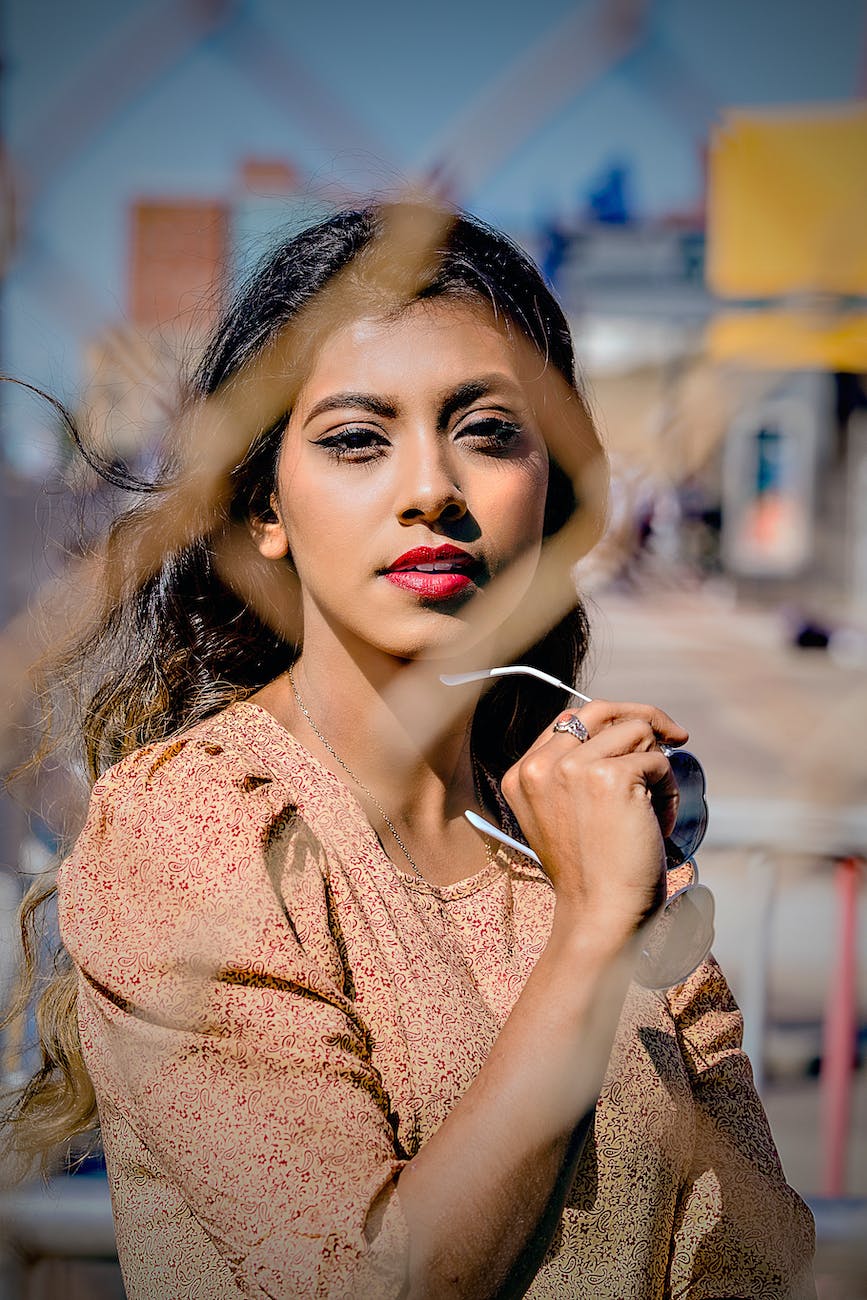 photo of woman near chain link fence