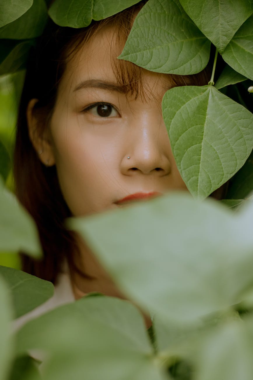 girls face on green leaves