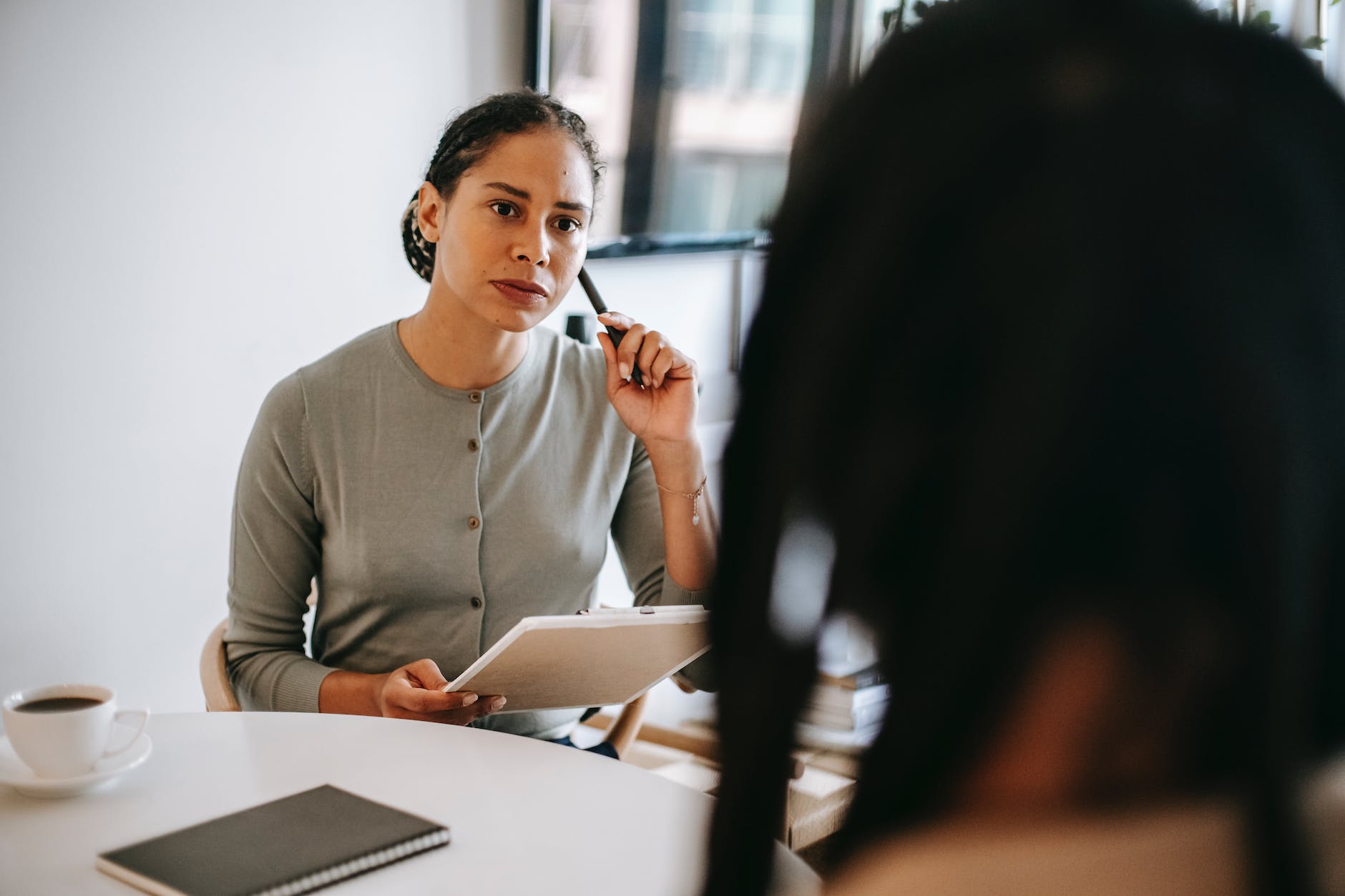 serious ethnic psychotherapist listening to clients complains