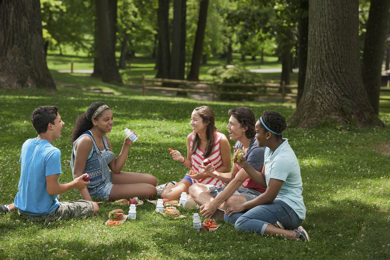 Teens eating at a summer