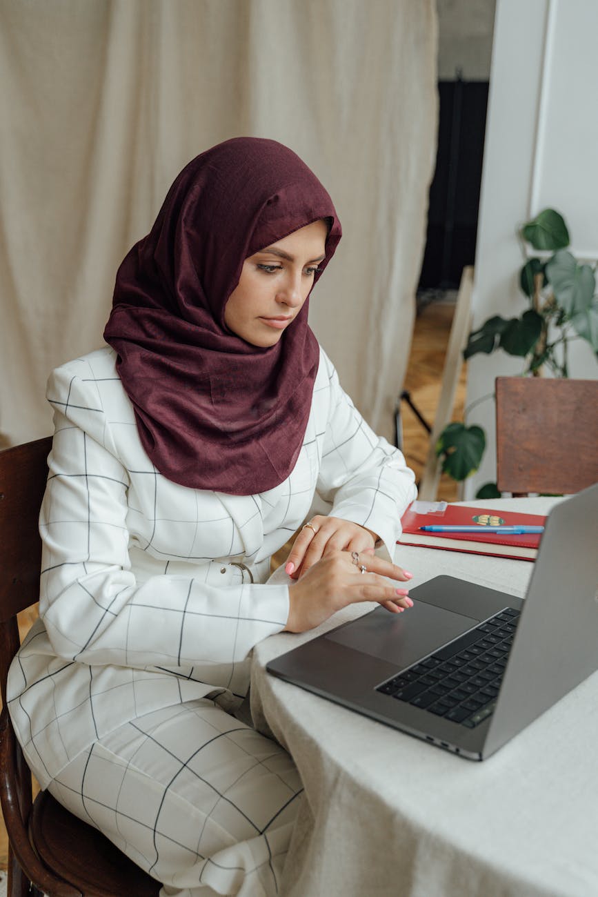 muslim woman using macbook